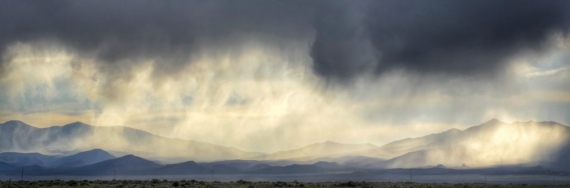 Storm light breaking over a range of mountains